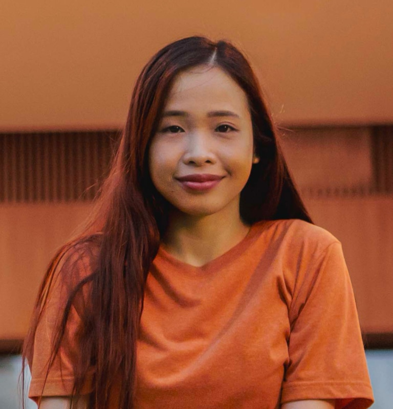 portait of adult female in orange shirt